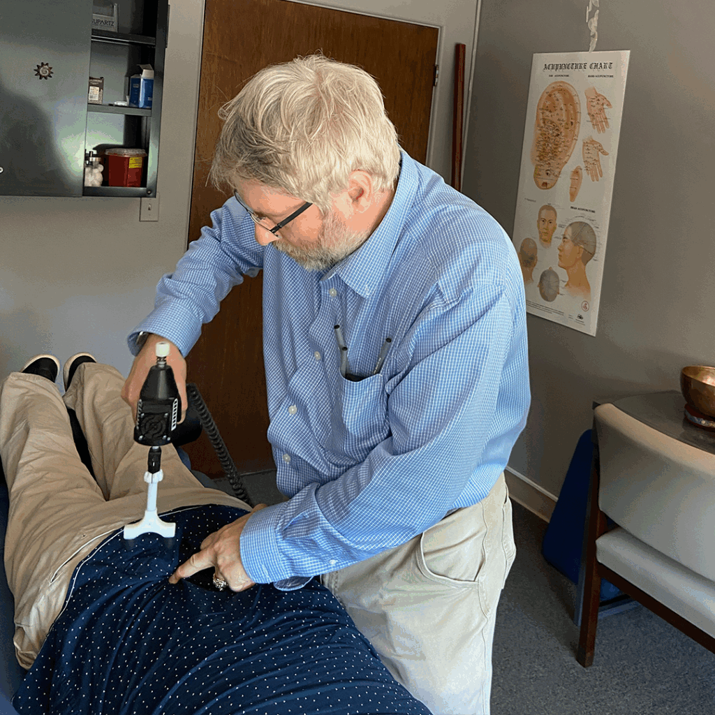 Dr. Paul Rieselman attend patient with activator method treatment